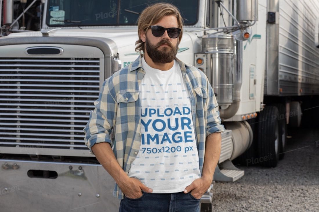 man wearing a t-shirt and posing in front of his truck